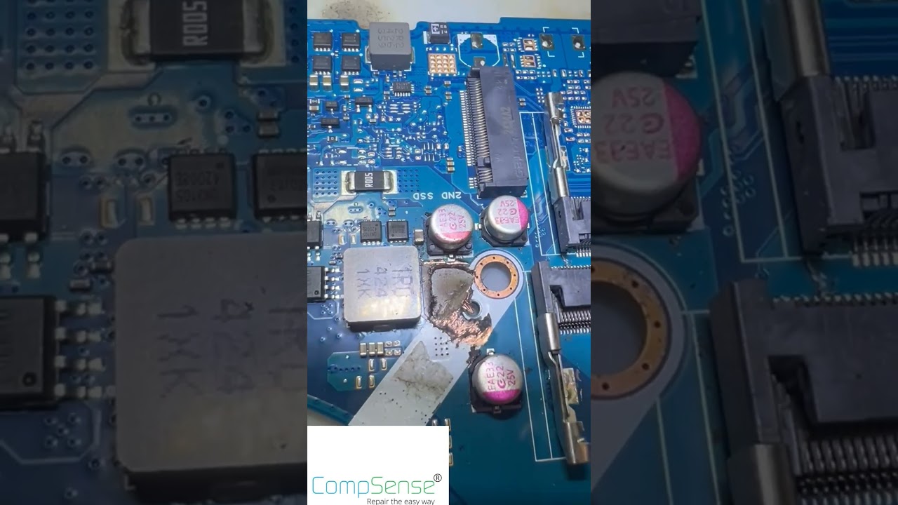 Burnt ASUS TUF gaming laptop motherboard under repair at the CompSense workshop