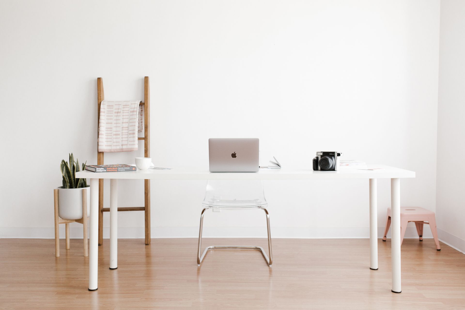 Silver MacBook on a clean white desk, ready for service